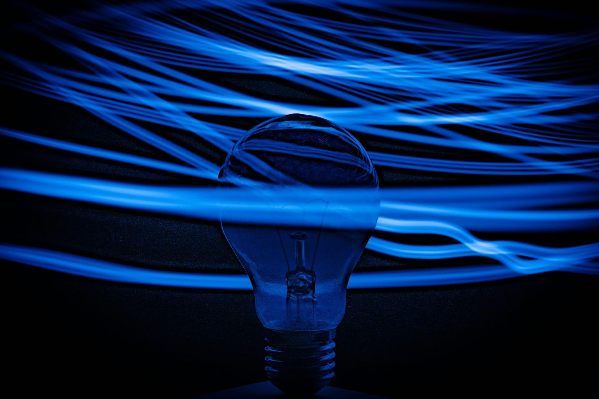 A light bulb illuminated with blue lines, symbolizing creativity and innovation.