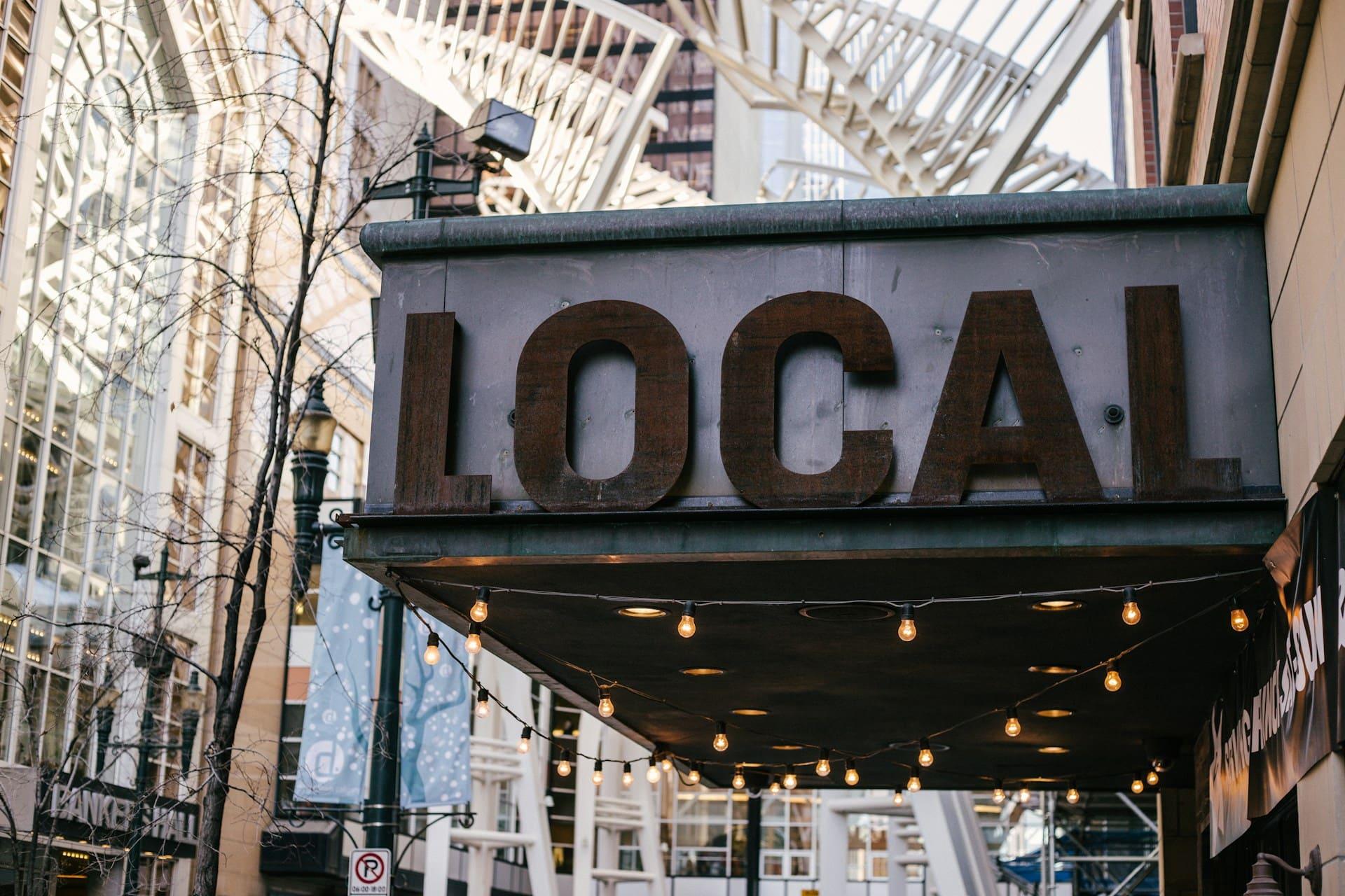 A street sign displaying the word 'Local', indicating nearby businesses or attractions.